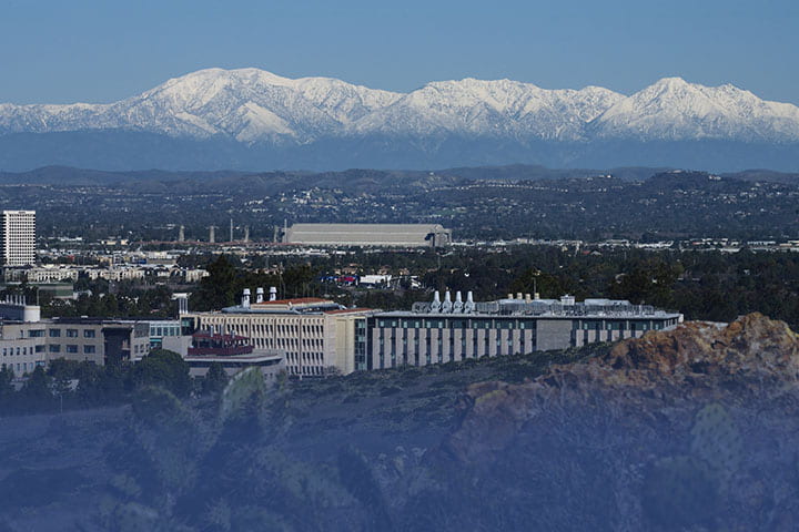 Image of UCI with white-capped mountains in the background